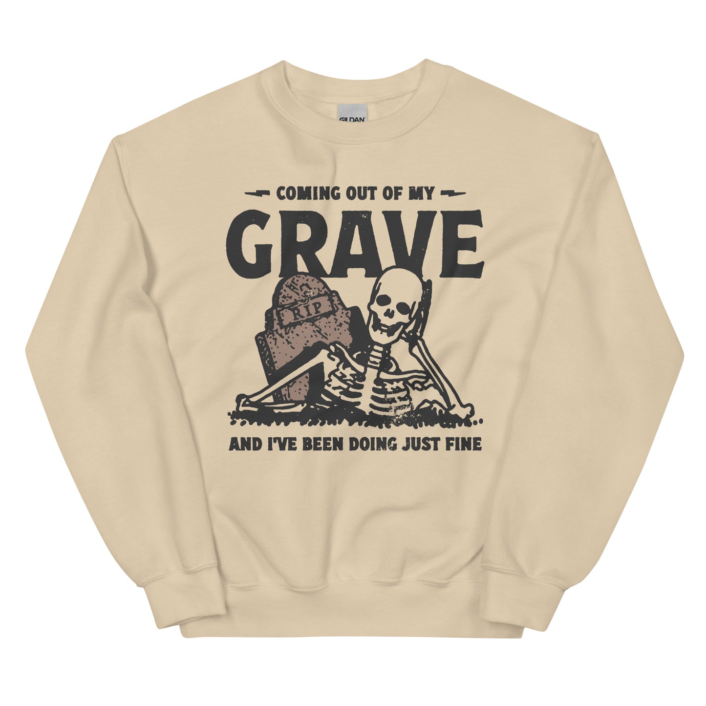 Beige crewneck sweatshirt with a black graphic of a smiling skeleton rising from the grave with the text "coming out of my grave and I've been doing just fine" in a bold graphic print