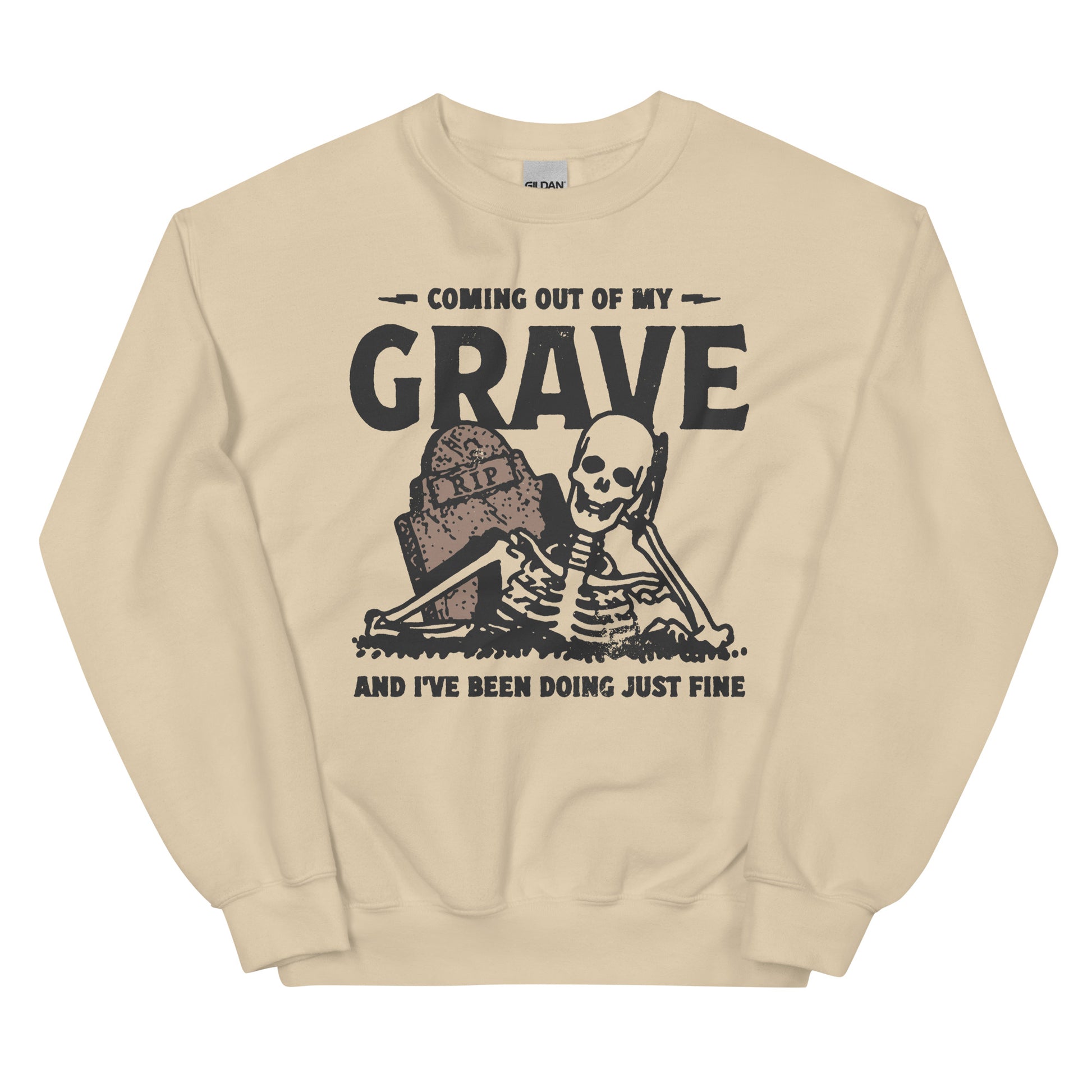 Beige crewneck sweatshirt with a black graphic of a smiling skeleton rising from the grave with the text "coming out of my grave and I've been doing just fine" in a bold graphic print