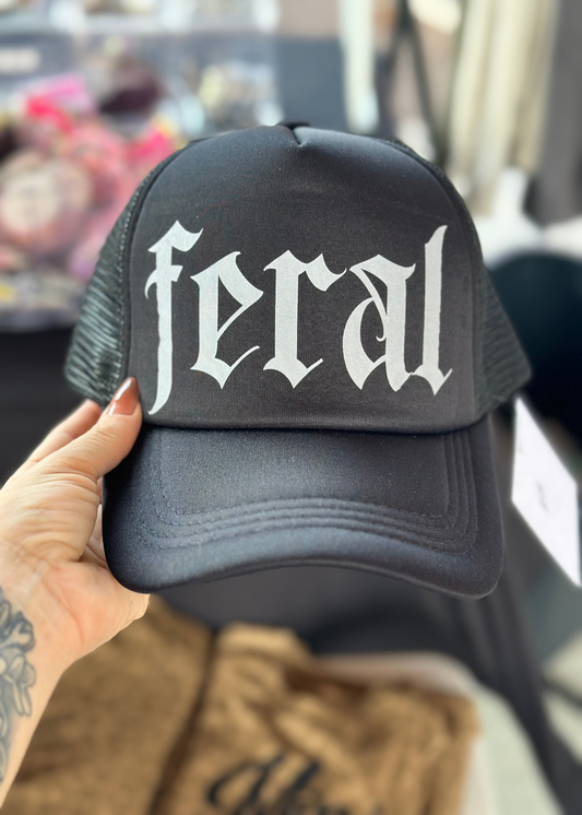 All black foam front hat with grey text reading "FERAL" in a west coast font